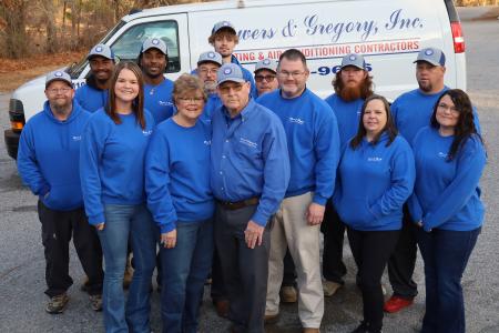 Powers and Gregory Owners stand with Employees outside of the Shop next to a Powers and Gregory Van